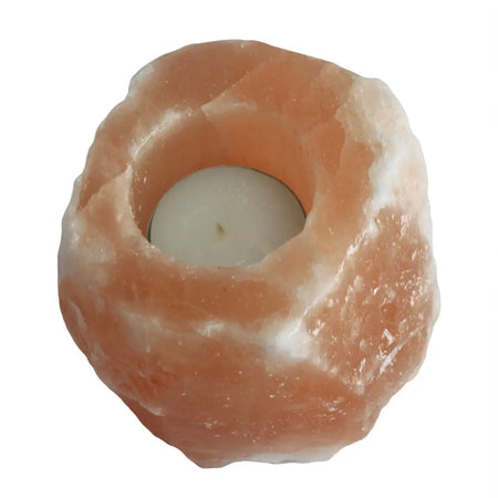 A rustic pink himalayan salt tealight holder with a smooth crystalline texture and a central circular opening