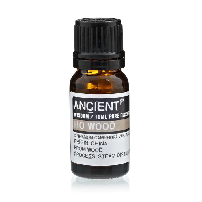 A small amber glass bottle of ho wood essential oil with a black cap labeled ancient wisdom wood essential oil 10ml