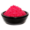 Home comforts simmering granules bright pink crystalline bath salts in a sleek black ceramic bowl for bedroom use
