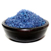 A dark rustic wooden bowl filled with blue simmering granules for a peaceful home hallway setting