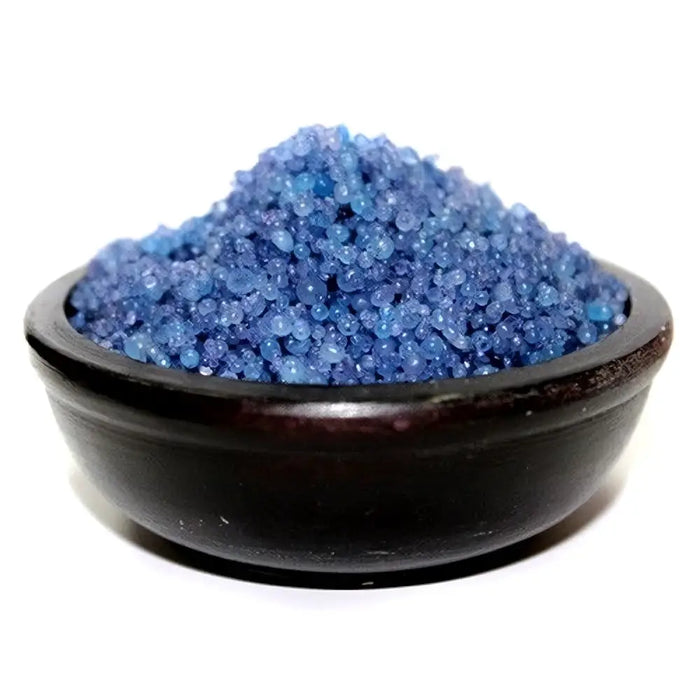 A dark rustic wooden bowl filled with blue simmering granules for a peaceful home hallway setting