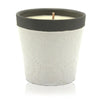 White ceramic candle jar with embossed floral pattern and black rim filled with forever vanilla soy wax