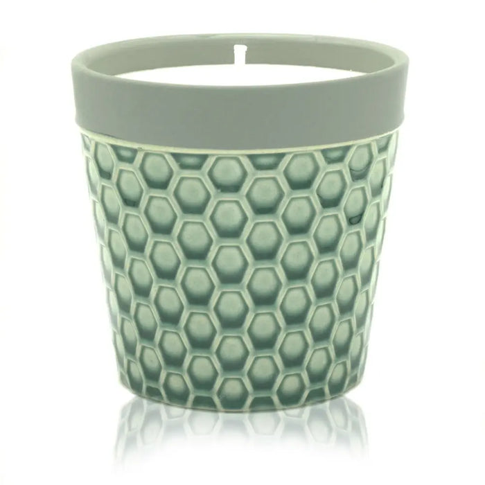 A sage green ceramic Home is Home candle pot with textured honeycomb pattern and light gray rim for soy wax fruit basket
