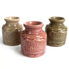 Three brown ceramic home oil burners with a raised love a home sweet home emblem for wax melts