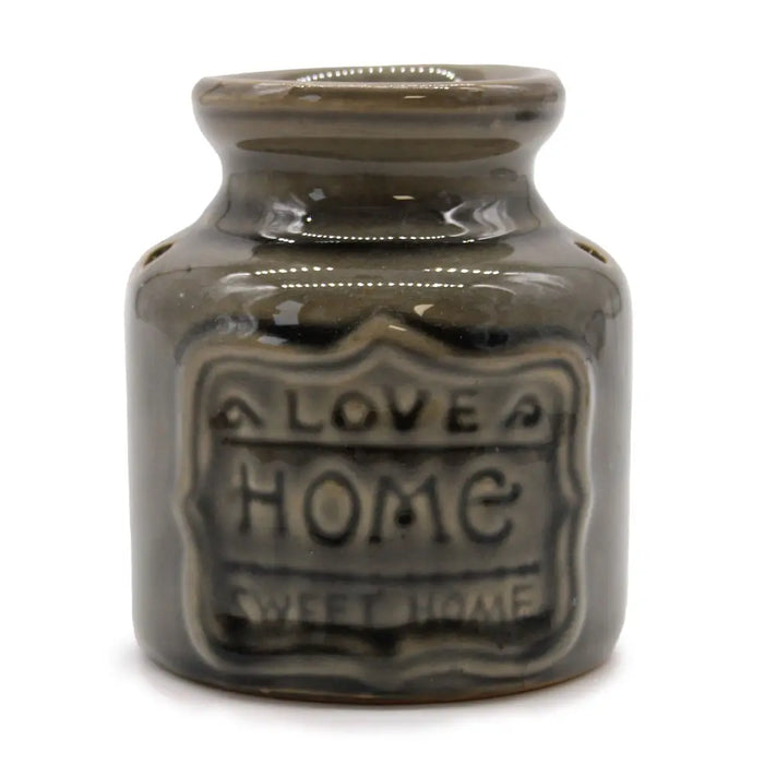 A matte gray ceramic home oil burner jar with rounded neck and embossed love home sweet home label for wax melts