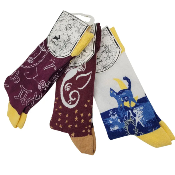 Three pairs of hop hare bamboo short socks with zodiac and celestial designs in maroon white and blue with yellow accents