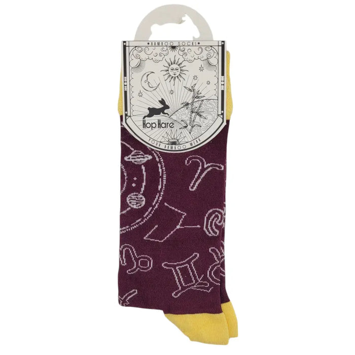 Maroon and yellow bamboo short socks with white zodiac symbols and celestial designs on a hop hare tag