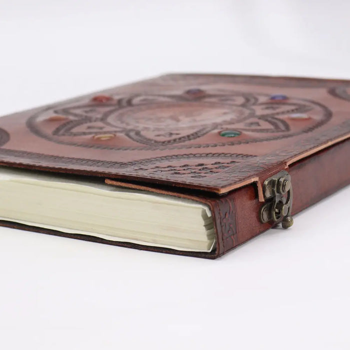 Brown leather tomb book with embossed dragon mandala, chakra stones, and metal clasp measuring 13 by 10 inches