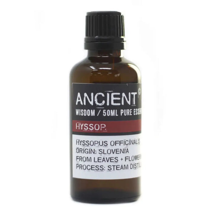 A dark amber glass bottle of hyssop essential oil 50ml with a black cap and label showing allergen declarations and steam distillation