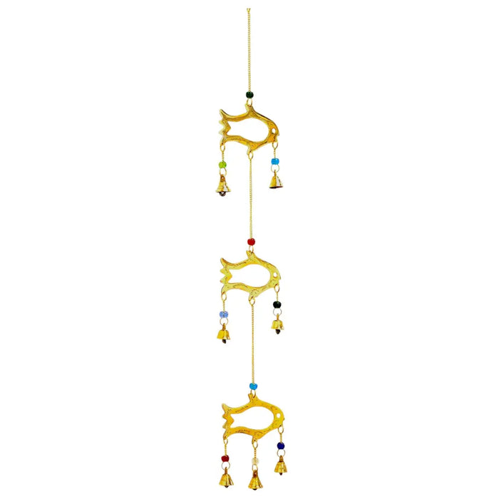 Golden brass fish-shaped wind chime with 7 bells and colorful beads hanging outdoors