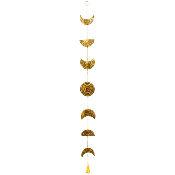 Golden brass moon phases wall hanging with hammered texture and small yellow tassel at the bottom with a bell