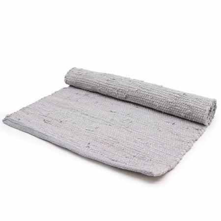 Gray chunky knit indian handloom cotton rug showing textured woven pattern in a simple setting