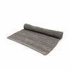 Gray indian handloom cotton rug with textured ribbed surface and rolled edge in small charcoal size