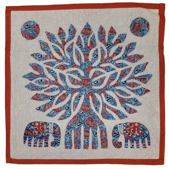 A square indian patchwork cushion cover with a red and blue paisley floral design and an orange border