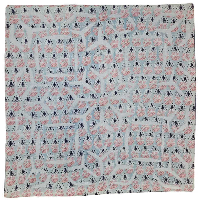 A light blue indian patchwork cushion cover with pink watermelon slices and black silhouette patterns
