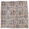 A square indian patchwork cushion cover with navy blue, cream, and beige circular and geometric motifs