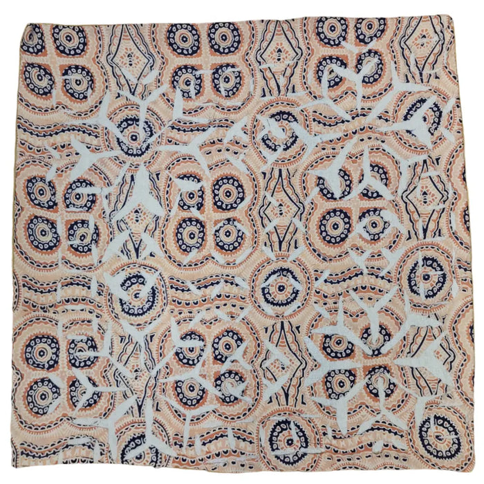 A square indian patchwork cushion cover with navy blue, cream, and beige circular and geometric motifs