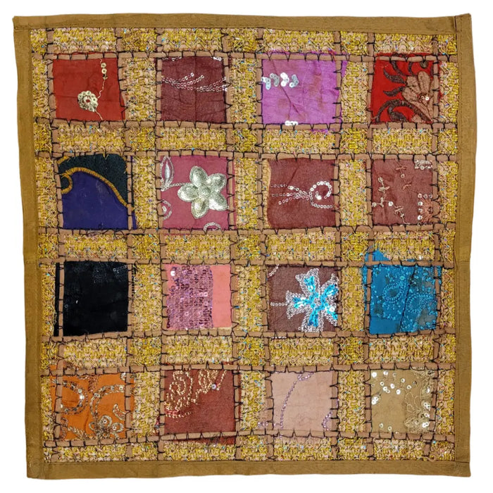 A vibrant standard cushion cover with patchwork sari tiles in red purple blue black and orange with embroidery details