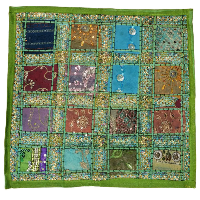 A vibrant patchwork indian sari tile standard cushion cover with colorful panels and gold thread embroidery and a green border