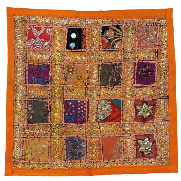 Vibrant orange-bordered indian sari tile standard cushion cover with colorful embroidered fabric squares in reds and blues