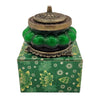 Green glass incense burner with ornate brass lid and base in an antique style glass jar for scented candle use
