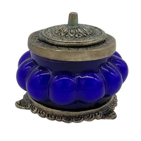 Deep blue glossy glass jar incense burner with ornate silver metal lid and base in antique style nag champa design