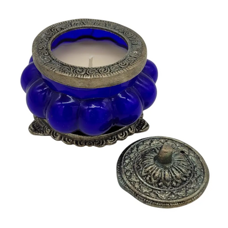 Deep blue glass jar indian scented candle in antique style with ornate silver lid featuring nag champa scent