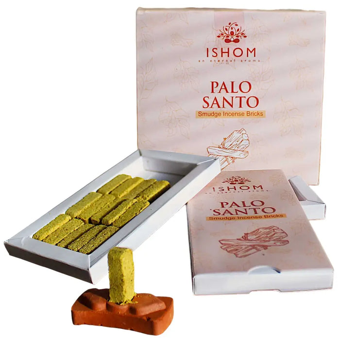 Ishom incense smudge bricks of yellowish-green palo santo in a white box with a terracotta burner stand