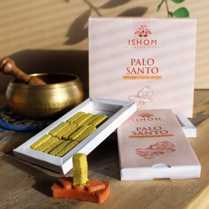 A pale yellowish green palo santo incense smudge brick neatly arranged in a white ishom box with matching packaging