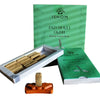 Ishom patchouli oudh incense smudge bricks in a green box with a white interior and an orange clay holder