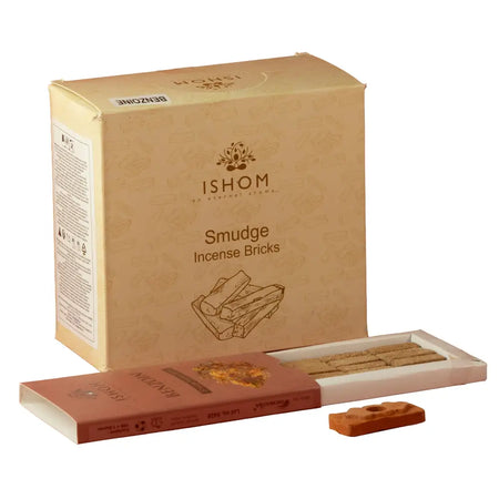Tan cardboard box of ishom benzoin smudge bricks with a reddish-brown tray and loose benzoin smudge bricks