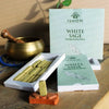 Ishom white sage incense smudge bricks in green branded white box arranged on wooden surface for smudging rituals