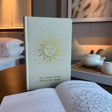 Ivory gratitude journal with beige linen cover gold sun illustration and my days are full of sun text on 120 pages