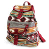 A jacquard backpack with earthy red green brown and beige geometric patterns and maroon leather straps and buckles