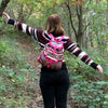 Jacquard backpack in pink with a vibrant multicolored geometric pattern and bright pink straps made of fabric material