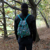 Teal and green jacquard backpack with geometric pattern and matching straps made of canvas material