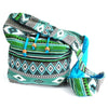 A vibrant teal jacquard student bag with green and turquoise geometric patterns and a blue interior lining