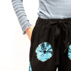 Black tie-dye lounge pants with vibrant blue circular patterns and a drawstring waist in Japanese style