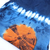 Japanese style lounge pants with vibrant orange and blue tie-dye fabric and a circular pattern with dark intricate lines