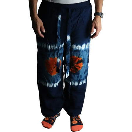 Japanese style lounge pants in dark blue tie dye with bold orange flowers and white streaks made from soft fabric