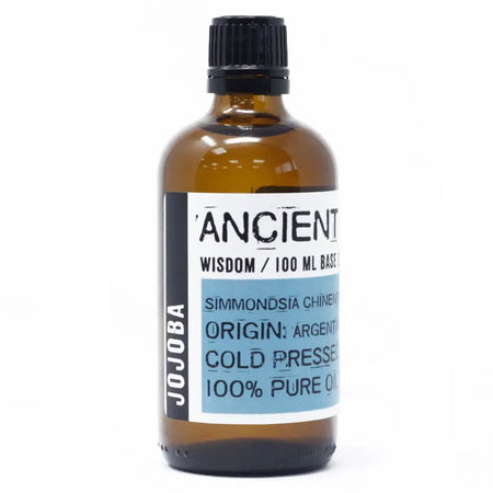 A brown glass bottle of jojoba oil with a black screw cap labeled ancient wisdom 100 ml base by jojoba