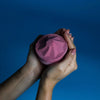 A jumbo pink bath bomb with a faceted geometric design made with sodium lauryl sulfoacetate razzle dazzle