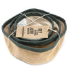 Set of three natural jute baskets with dark green rims neatly coiled and tied together for storage