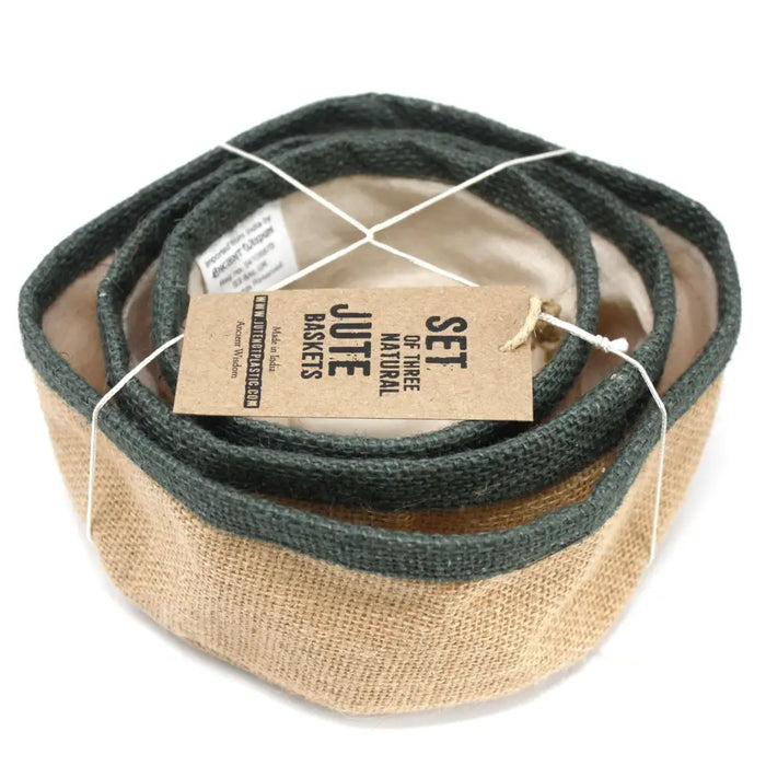 Set of three natural jute baskets with dark green rims neatly coiled and tied together for storage