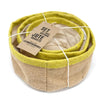 Set of three natural jute baskets with olive green rims and beige interiors neatly coiled together