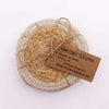 Handwoven circular jute and cotton coaster in natural beige and tan tied with rustic twine set of 4