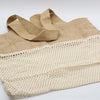 Beige woven canvas tote bag with cream cotton mesh panel showing natural jute and cotton mesh bag design