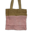 A pink cotton mesh bag with olive green fabric handles and a solid top panel made from jute and cotton materials
