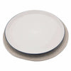 A minimalist white ceramic plate with a navy blue rim on an ivory jute and cotton woven placemat