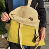 Beige and olive green canvas tote bag with wooden button closure made from jute and cotton materials